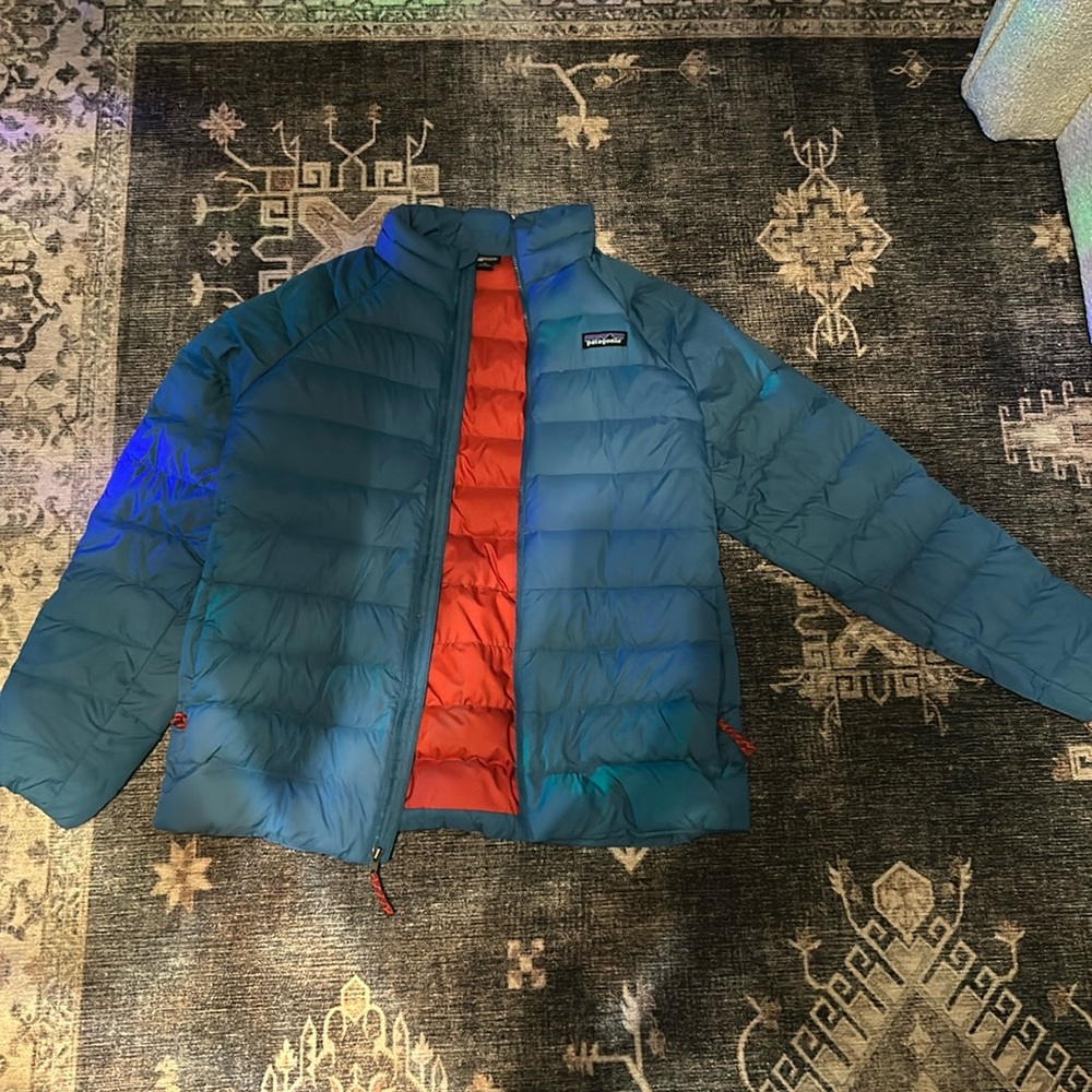 Patagonia jacket. Blue and orange. Very comfortable and keeps you warm.Size 14XL